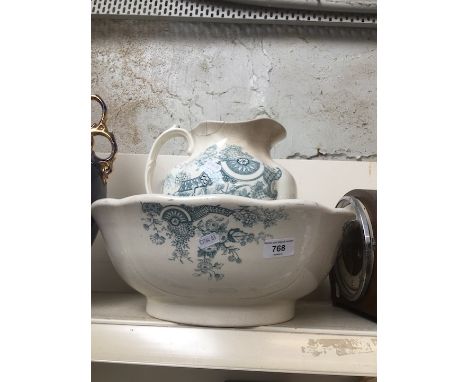 A jug and bowl and a mantel clock - both damaged 