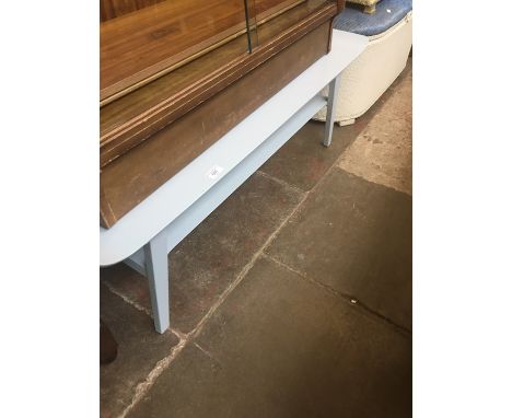 A light blue painted retro coffee table. 
