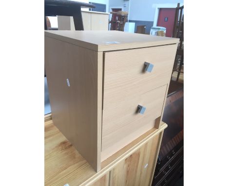 A light wood effect bedside chest of two drawers. 