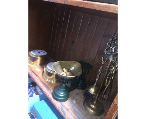 A brass companion set, a pair of brass scales with weights and a brass clock and barometer on wooden plinth 