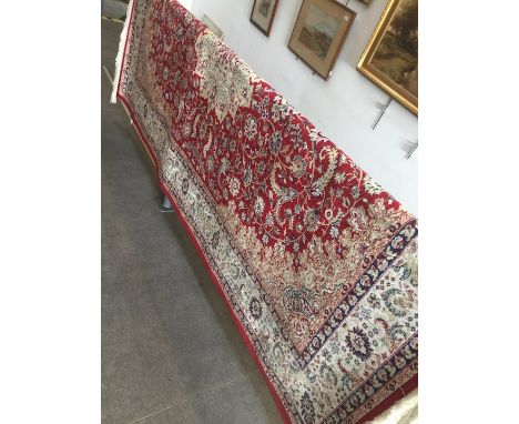 A red ground Keshan style carpet 230cm x 160cm. 