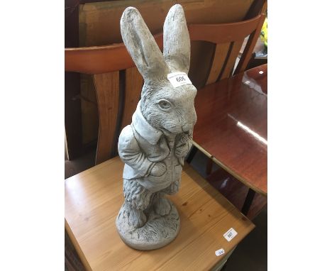 A stone garden ornament of a rabbit. 