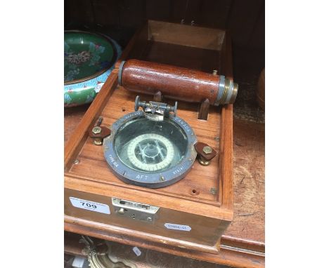 A cased compass and flash light. 