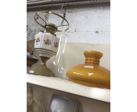 Brass and pottery oil lamp with funnel and amber shade 