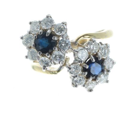 18ct sapphire and diamond double cluster cross-over design ring, each cluster with a single sapphire 0.30ct approx, in a surr