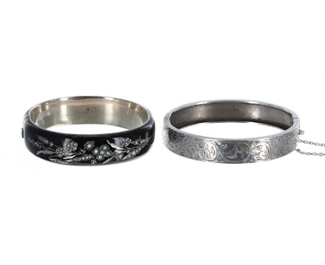 Silver and black enamel bangle, with floral seed pearl decoration,&nbsp; 33.3gm, 66mm wide; together with silver engraved ban
