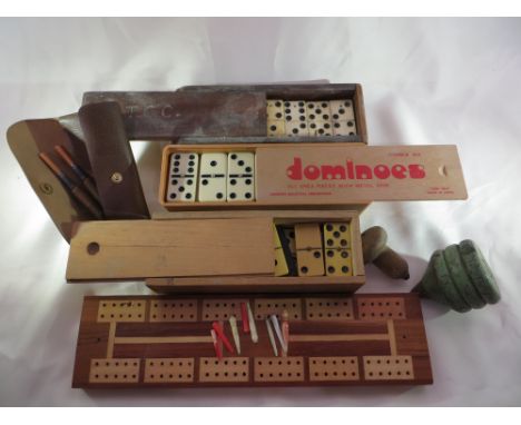 3x sets of dominoes, a cribbage board with some pegs, 2x spinning tops and a set of vintage darts with modern flights.