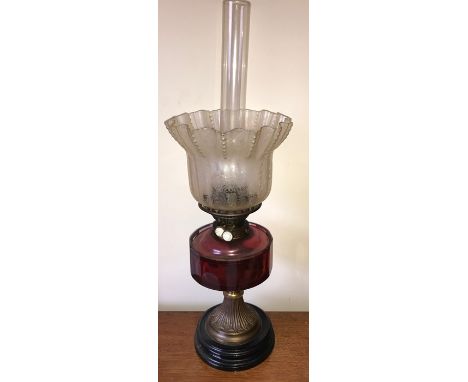 A good quality 19thC oil lamp, cranberry and brass with etched shade damage to metal around the burner otherwise good used co