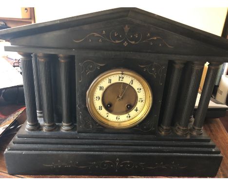 A 19thC black slate mantel clock with black and enamel dial. 