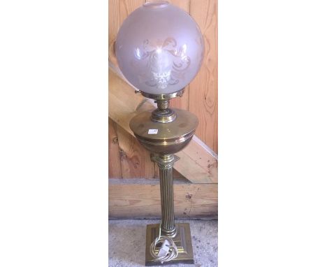 A brass electrified oil lamp, 74cms h. 