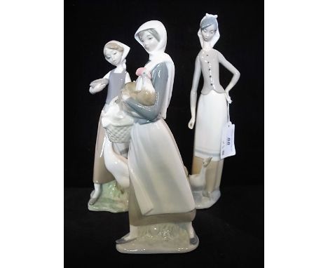 Three Lladro figurines of ladies, each with poultry, the tallest 27cm.
