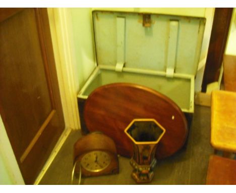 A tin travelling trunk, containing gilt framed mirrors, painted vase, mantle clock and other items.