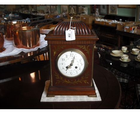 A late 19th/early 20th century mahogany and brass inlaid bracket clock, having pineapple finial with a scalloped shape mount,