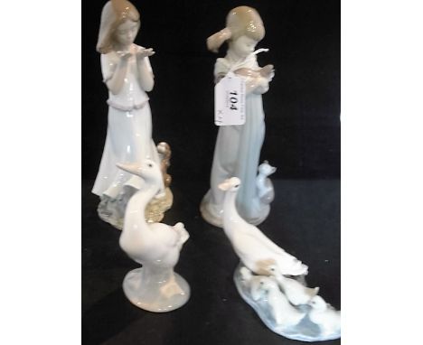 Two Lladro figurines of girls, one with kittens and one with a puppy, together with two Lladro models of geese, the tallest 2