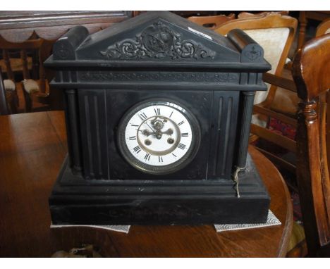 A Victorian slate mantle clock of classical form, the enamel dial bearing Roman numerals, 38cm x 34cm.