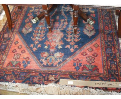 An Indian carpet, with blue central ground and pink corners within a dark blue border, 200cm x 170cm.