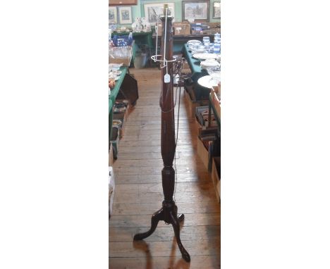 A mahogany standard lamp with carved decoration on tripod base, 152cm.