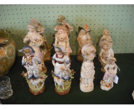 Twelve Continental bisque and ceramic figurines, various sizes.