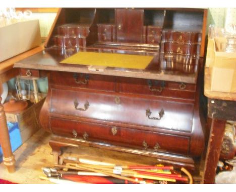 A mahogany Dutch Bombe bureau, late 19th century, the interior fitted with drawers, cupboard and a well, over two short and t