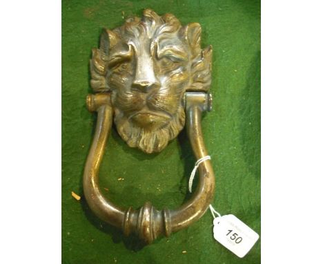 A 20th century brass door knocker, formed as a lion's head.