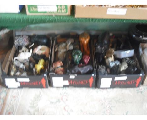 Three boxes containing a large quantity of elephants, ceramic, wood and other materials.