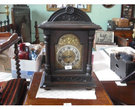 An early 20th century oak cased mantle clock, having German movement, the brass and enamel dial bearing Arabic numerals, 47cm