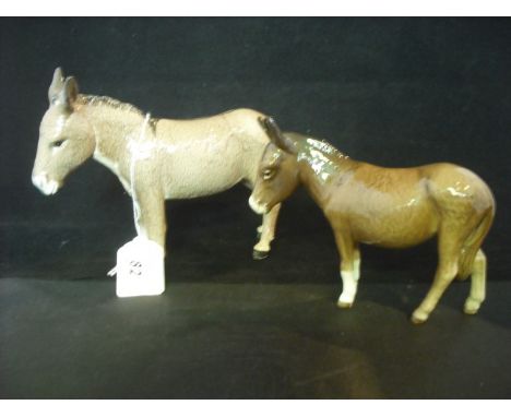 Two Beswick donkeys, one light fawn in colour, 13.5cm tall, the other in gloss brown, 11cm tall (both AF).