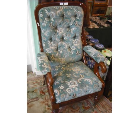 A Victorian mahogany reclining armchair with slide-out foot rest, having upholstered button back seat and arm rests, stamped 