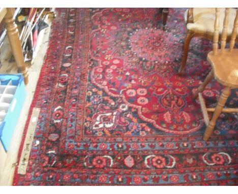 A large early 20th century Turkish carpet, having stylized floral pattern throughout, 310cm x 200cm.