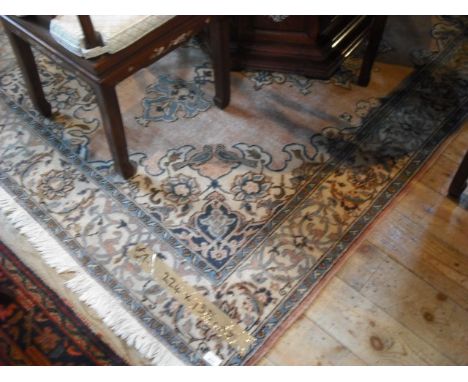 A 20th century machine made carpet, the large central medallion decorated with stylized floral forms and birds, within blue a