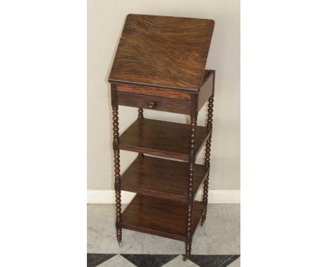 A 19th century simulated rosewood four-tier whatnot, the upper tier with hinged adjustable reading stand over single drawer, 