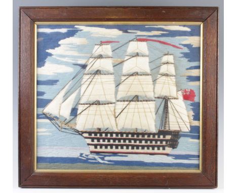 A sailor's woolwork depicting a three-masted frigate flying the British naval ensign, 34 x 38cmVery light staining.Otherwise 