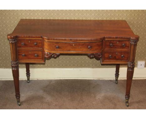 A Victorian plum pudding mahogany kneehole dressing table, having a bowfront centre drawer flanked by twin short drawers, to 