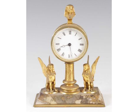 A circa 1900 Egyptian Revival gilt brass mantel clock, having unsigned white enamel dial, the barrel case decorated with hier