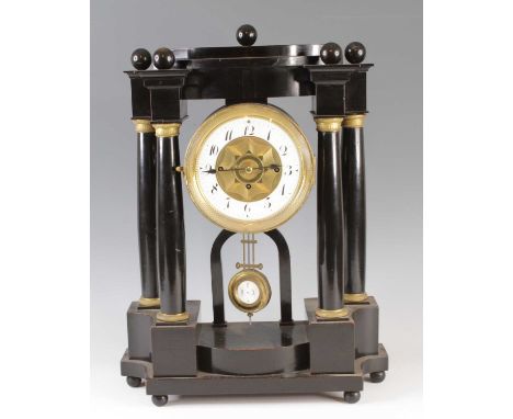 A 19th century ebonised mantel clock of architechtural form, having an enamelled chapter ring with Arabic numerals and engine