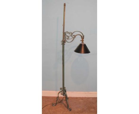 A lacquered and painted wrought iron standard lamp, the branch arm with rise-and-fall action, on scroll base, max h.173cm