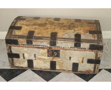 A 19th century hide, metal bound and further studded domed hinge topped travelling trunk, having iron end carry handles, the 