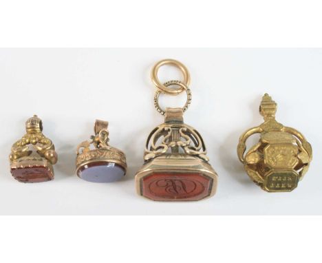 Four assorted yellow metal fob pendants, being a yellow fob with a 23x17mm carnelian intaglio engraved with initials DN, with