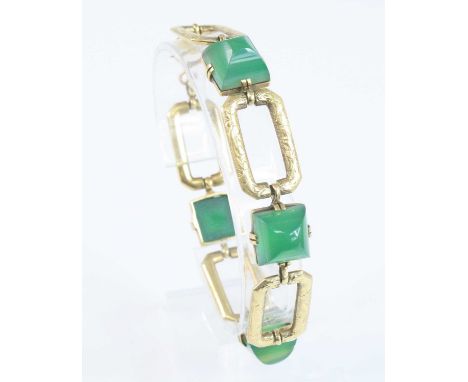 A yellow metal chrysoprase bracelet, comprising four domed square chrysoprase cabochons alternating with five engraved rectan