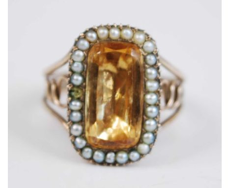 A Georgian yellow metal memorial ring, comprising a central lozenge shaped citrine in a foil closed back setting within a bor