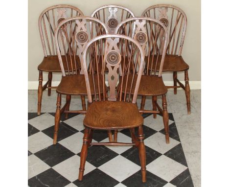 A set of six 19th century provincial splat and stick back elm seat, yew and fruit wood kitchen chairs, each having dish seats