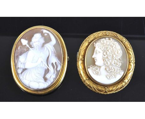 Two yellow metal shell cameo brooches, one depicting a Goddess wearing a lion's pelt within a rope edge surround, with roller