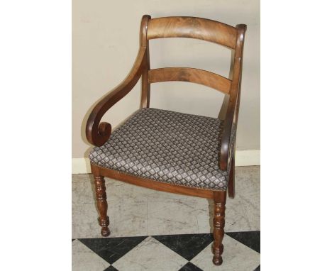 A Regency mahogany barback scroll elbow chair, having a floral upholstered stuffover seat, on bobbin turned forelegs, w.55.5c