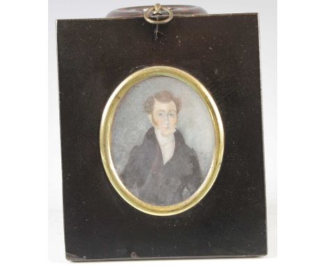 Mid-19th century English school - half-length portrait of a young man wearing a black jacket, miniature watercolour on ivory,