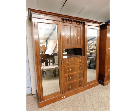 EDWARDIAN MAHOGANY COMPENDIUM WARDROBE CENTRALLY FITTED WITH TWO CUPBOARD DOORS OVER AN OPEN SHELF OVER TWO DRAWERS OVER THRE