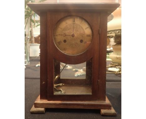 Antique wood and glass cased chiming mantel clock with brass face