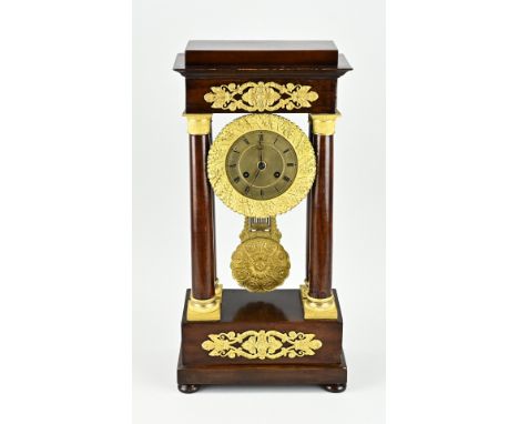 Antique mahogany empire column clock with fire-gilt bronze decoration. First half 19th century. Eight-day movement, half-hour