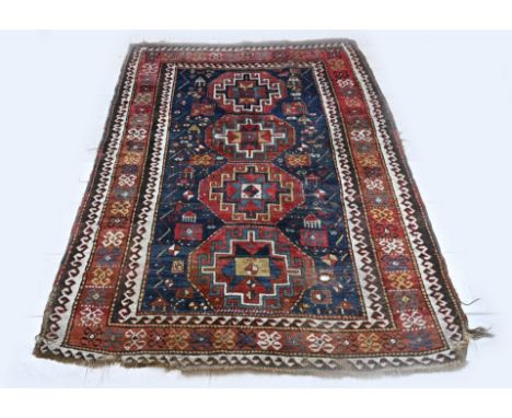 Antique hand-knotted Persian rug. Colour: blue. Carpet has a hole. Dimensions: 240 x 175 cm. In fair condition.