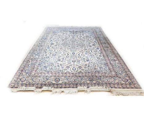 Very large hand-knotted Persian carpet. Light in colour, completely floral decorated. Dimensions: 390 x 305 cm.