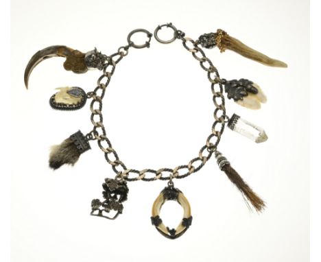 Silver hunting trophy in the shape of a chatelaine, 835/000, decorated with 9 charms with teeth, crystal and claws. Total app